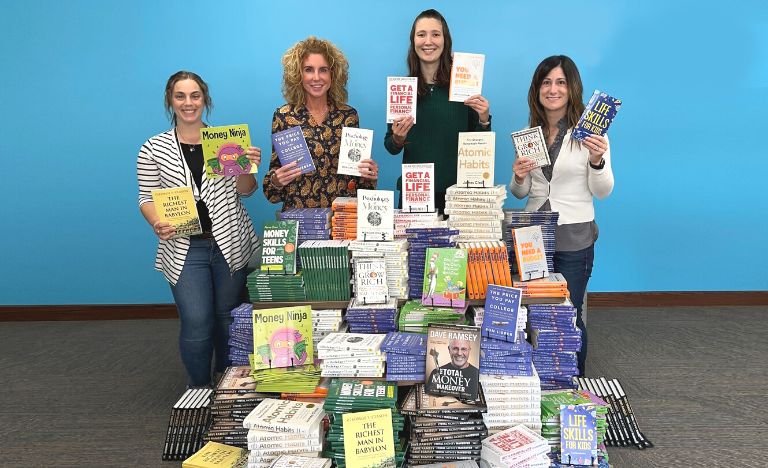 Members First Credit Union with books purchased from grant